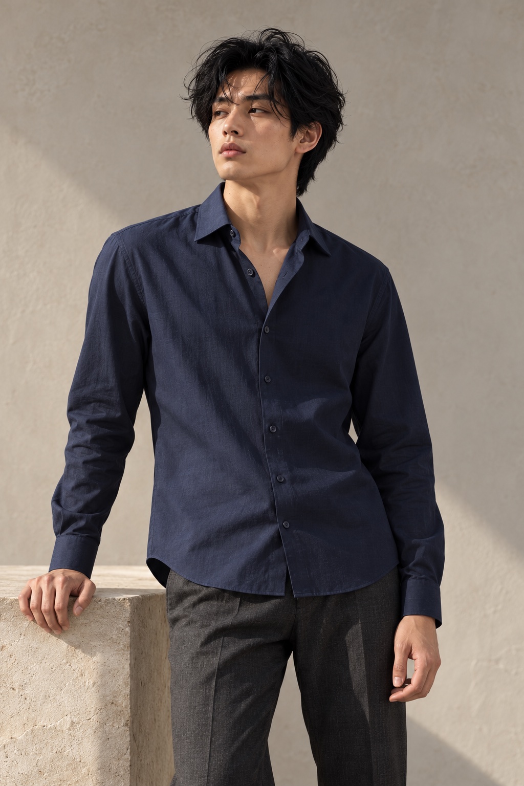 Navy shirt campaign concept, model resting a hand on stone